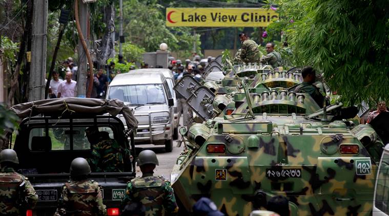 Bangladesh security personnel stand on top of armored vehicles after militants took hostages at a restaurant popular with foreigners in Dhaka, Bangladesh, Saturday, July 2, 2016. Bangladeshi forces stormed the Holey Artisan Bakery in Dhaka's Gulshan area where heavily armed militants held dozens of people hostage Saturday morning, rescuing some captives including foreigners at the end of the 10-hour standoff. (AP Photo)