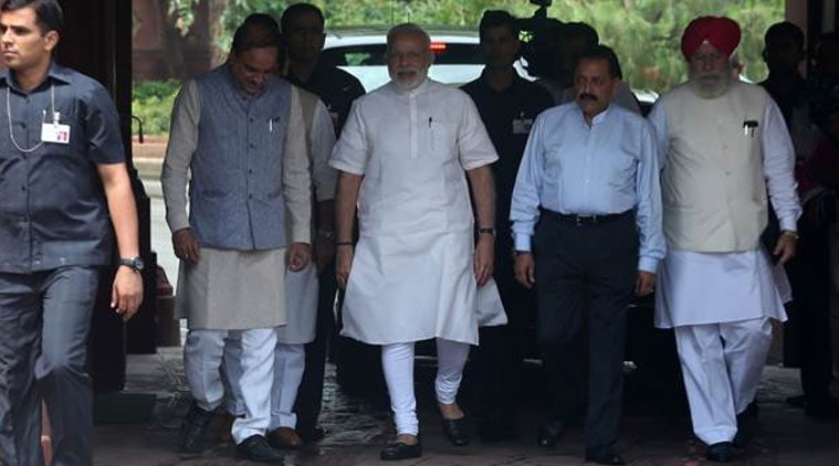 Prime Minister Narendra Modi, center, talks to his cabinet colleagues as they walk to brief the media, after his arrival at the opening day of the monsoon session of the parliament, in New Delhi on Monday, Express PhoTo By Amit Mehra July 18, 2016