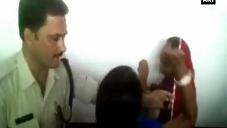 Woman cornered by activist while police tries to intervene. ANI video screenshot
