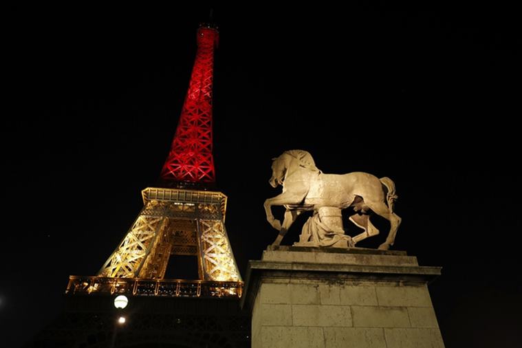 The Eiffel Tower is seen with the black, yellow and red colours of the Belgian flag in tribute to the victims of today's Brussels bomb attacks, in Paris, France, March 22, 2016. REUTERS/Philippe Wojazer