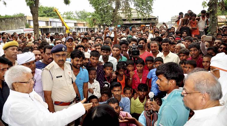 Patna: RJD chief Laloo Prasad Yadav meets to flood victims at flood affected area Didarganj in Patna on Monday. PTI Photo(PTI8_22_2016_000299B)