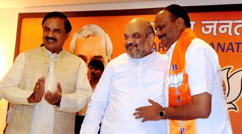 New Delhi: Brajesh Pathak (R) with BJP President Amit Shah and Tourism Minister Mahesh Sharma after joining BJP in New Delhi on Monday. Pathak quit BSP to join BJP. PTI Photo (PTI8_22_2016_000291B)