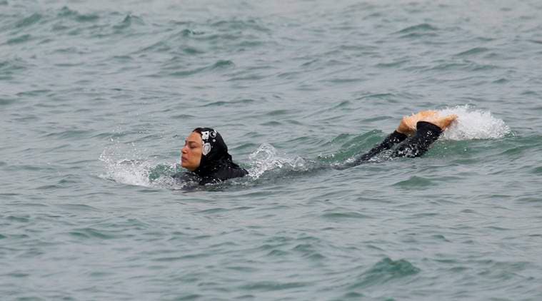 A Muslim woman wears a burkini, a swimsuit that leaves only the face, hands and feet exposed, as she swims in the Mediterranean Sea in Marseille, France, August 17, 2016. REUTERS/Stringer