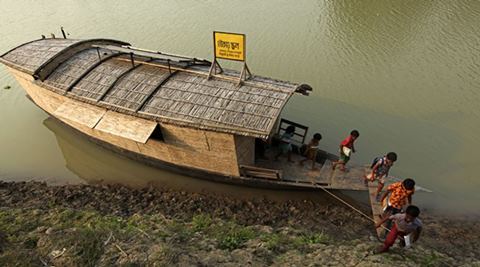 Students return home after the end of the classes for the day. The floating boat school moves from one area to another and goes to the children for giving education as the children don't go to the traditional school because of lack of communication during flooding, Billdohor, Natore.