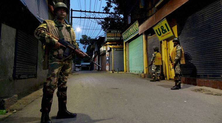 Srinagar: Security jawans stand guard during night curfew in Lal Chowk area of Srinagar on Sunday. Security has been stepped up in Kashmir for the Independence Day functions. PTI Photo by S Irfan (PTI8_15_2016_000076B)