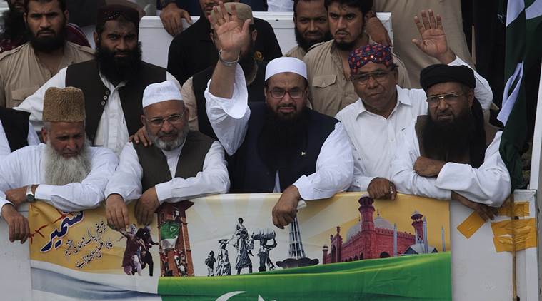 Hafiz Saeed, center, head of a religous group Jamaat-ud-Dawa waves to supporters while he with other leaders leads a rally to mark Pakistan Independence Day in Karachi, Pakistan on Sunday, Aug. 14, 2016. The Pakistani nation is celebrating its 70th Independence Day, to mark its independence from the British rule in 1947. (AP Photo/Shakil Adil)