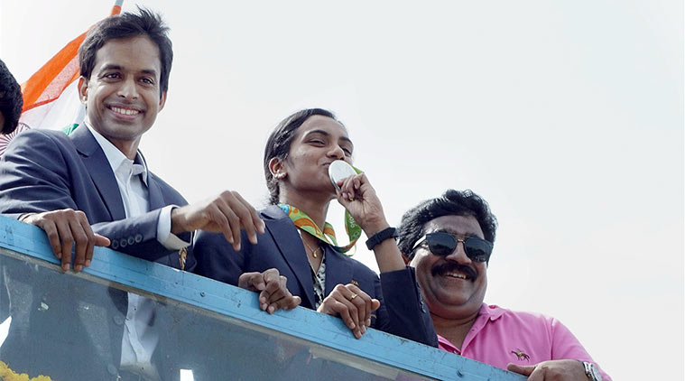 Olympic Silver medalist PV Sindhu along with her coach Pullela Gopichand receives warm welcome by people in Hyderabad on Monday. (Source: PTI)