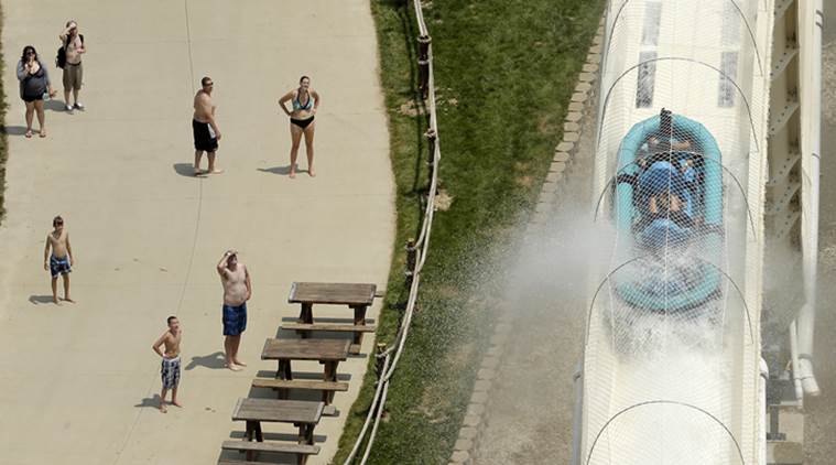 FILE - In this July 9, 2014 file photo, riders are propelled by jets of water as they go over a hump while riding a water slide called "Verruckt" at Schlitterbahn Waterpark in Kansas City, Kan. A 12-year-old boy died Sunday, Aug. 7, 2016, on the Kansas water slide that is billed as the world's largest, according to officials. Kansas City, Kansas, police spokesman Officer Cameron Morgan said the boy died at the Schlitterbahn Waterpark, which is located about 15 miles west of downtown Kansas City, Missouri. Schlitterbahn spokeswoman Winter Prosapio said the child died on one of the park's main attractions, Verruckt, a 168-foot-tall water slide that has 264 stairs leading to the top. (AP Photo/Charlie Riedel, File)