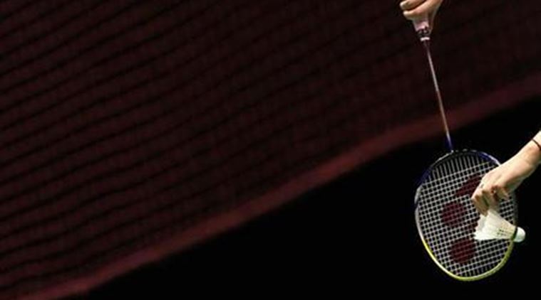 China's Gao Ling returns a shot to England's Anthony Clark and Donna Kellogg during their mixed doubles final match at the All England badminton championships in Birmingham, England March 11, 2007. REUTERS/Alessia Pierdomenico