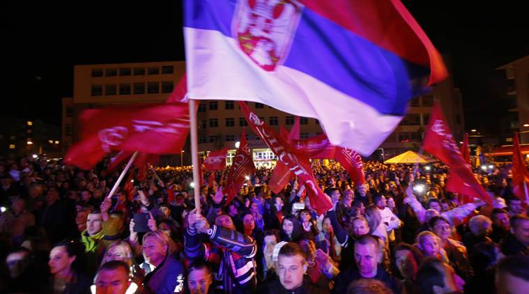 Bosnian people wave flags during the speech of Milorad Dodik, President of the Bosnian Serb region of Republic of Srpska, during celebrations after the result of the referendum in the Bosnian town of Pale, Bosnia, on Sunday Sept. 25, 2016. Sunday's vote asks residents of Republika Srpska whether to maintain a national holiday on Jan. 9, despite a ruling of Bosnia's constitutional court that the date discriminates against non-Serbs. (AP Photo/Amel Emric)