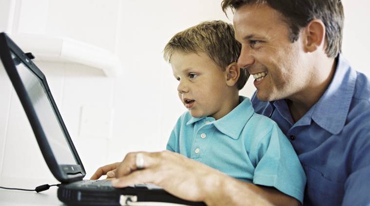 Father and son using a computer