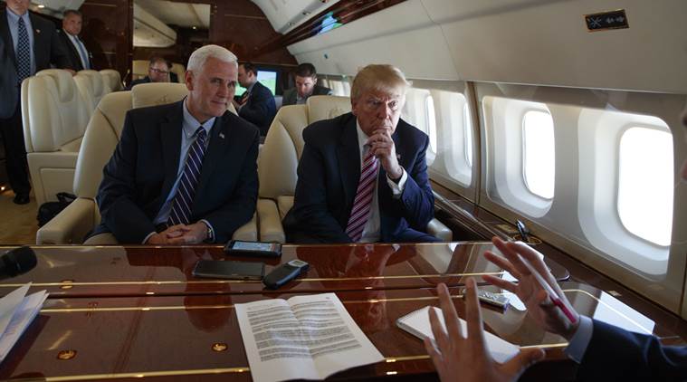 Republican presidential candidate Donald Trump talks with press, Monday, Sept. 5, 2016, aboard his campaign plane while flying over Ohio, as Vice presidential candidate Gov. Mike Pence, R-Ind., left, looks on. (AP Photo/Evan Vucci)