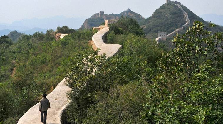 Suizhong : In this Wednesday, Sept. 21, 2016, photo, a villager walks across a restored section of the Great Wall in Suizhong County in northeastern China's Liaoning Province. Chinese officials are being pilloried over the smoothing-over of a crumbling but much-loved 700-year-old section of the Great Wall of China - a UNESCO World Heritage Site - in the name of restoration. AP/PTI(AP9_22_2016_000215B)