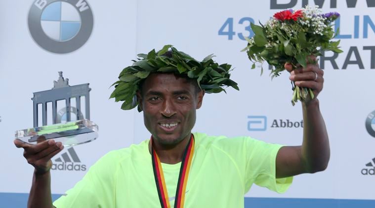 Winner Bekele of Ethiopia celebrates during the victory ceremony at the Berlin marathon in Berlin