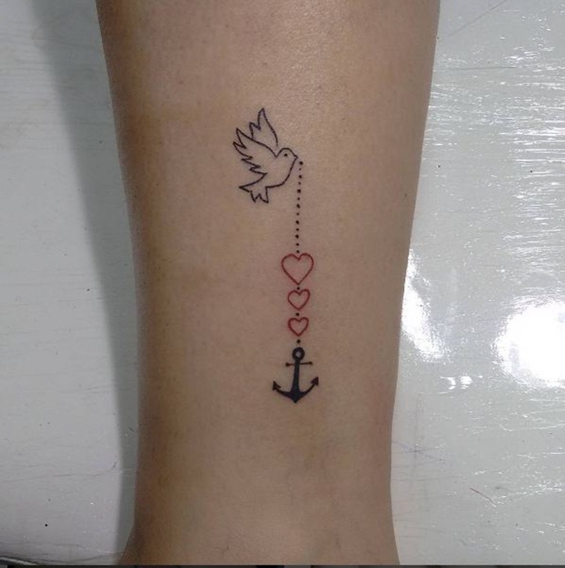 Tiny minimalistic anchor tattoo located on the wrist.