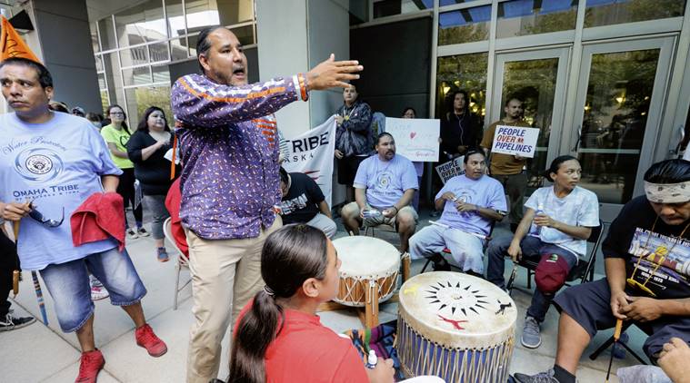 Sam Grant of the Omaha tribe addresses members of the Ponca, Santee, Winnebago and Omaha Tribes in Nebraska and Iowa along with others during a rally on Thursday, Sept. 8, 2016, in front of the Army Corps of Engineers offices in Omaha, Neb., to protest against the Dakota Access Pipeline in the Dakotas and Iowa. A judge is expected to rule Friday on whether to block construction of the pipeline that is supposed to pass close to the tribal reservation near the North Dakota-South Dakota border. (AP Photo/Nati Harnik)