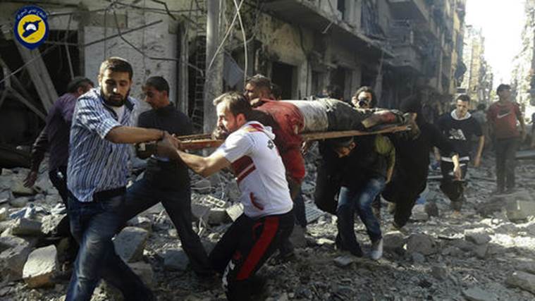 In this photo provided by the Syrian Civil Defense group known as the White Helmets, Syrians carry a victim after airstrikes by government helicopters on the rebel-held Aleppo neighborhood of Mashhad, Syria, Tuesday Sept. 27, 2016. With diplomacy in tatters and a month left to go before U.S. elections, the Syrian government and its Russian allies are using the time to try and recapture the northern city of Aleppo, mobilizing pro-government militias in the Old City and pressing ahead with the most destructive aerial campaign of the past five years. (Syrian Civil Defense White Helmets via AP)
