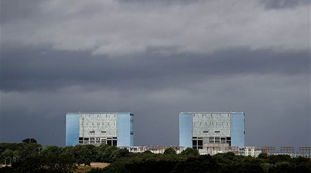 FILE - This is a  July 28, 2016  file photo of  of Hinkley Point A Magnox nuclear power station in Hinkley Point  Somerset, southwest England . The British government Thursday Sept. 15, 2016 has approved construction of the country's first new nuclear power plant in decades, to be built with Chinese investment. The government says in a statement that it has "decided to proceed" with the Hinkley Point plant. Prime Minister Theresa May unexpectedly stalled the deal after she took office in July. (Andrew Matthews/PA, File)