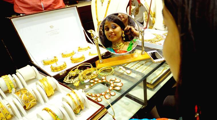 A Woman with gold ornaments at a jewellery shop on the occasion of Dhanteras in Jaipur on Monday. Express Photo by Rohit Jain Paras. 09.11.2015.