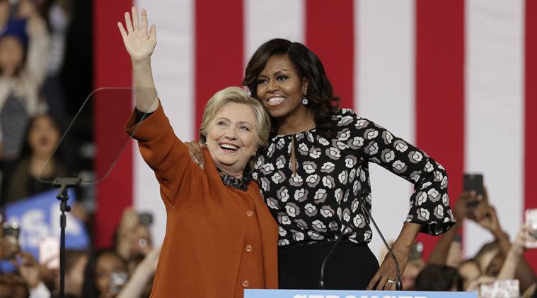 Democratic presidential candidate Hillary Clinton, accompanied by first lady Michelle Obama, greet supporters during a campaign rally in Winston-Salem. (AP Photo)