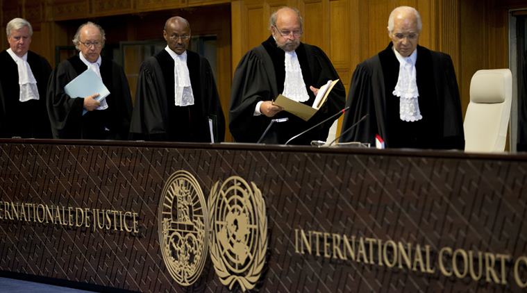Judges, with presiding judge Ronny Abraham of France, second right, re-enter the World Court in The Hague, Netherlands, Wednesday, Oct. 5, 2016 to read the verdict in the case of the Marshall Island versus Pakistan. The Marshall Island are taking India, Pakistan and the U.K. to court to urge those powers to resume negotiations to eradicate the world's nuclear stockpile, three separate rulings were handed down. (AP Photo/Peter Dejong)
