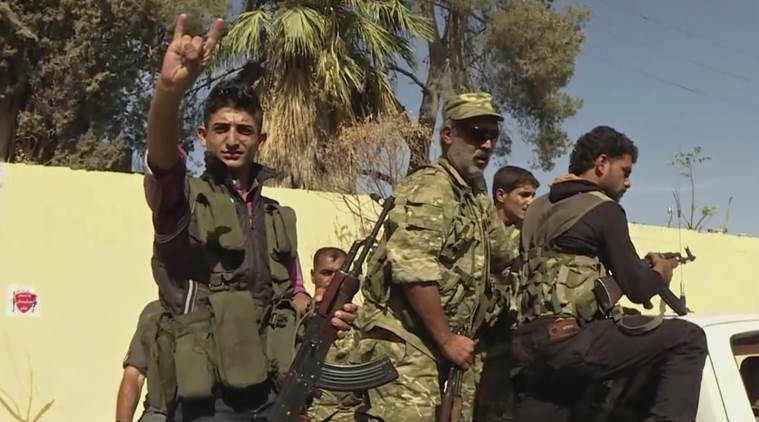 In this image made from video posted online by Qasioun News Agency, members of a Turkish-backed Syrian opposition force patrol in Dabiq, Syria, Sunday, Oct. 16, 2016. Turkish-backed Syrian opposition forces have captured the symbolically significant town of Dabiq from the Islamic State group, the factions said Sunday morning. A commander of the Syrian opposition Hamza Brigade said Islamic State fighters put up "minimal" resistance to defend the northern Syrian town before withdrawing in the direction of the much larger IS-held town of al-Bab to the south. The Islamic State group took control of the town, which had a prewar population of about 3,000 people, in August 2014. (Qasioun News Agency via AP)