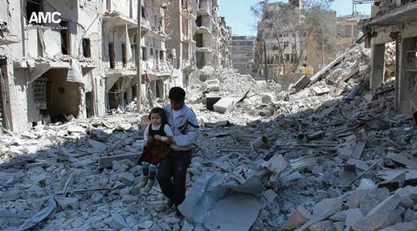 FILE -- In This April 21, 2014, file photo, provided by the anti-government activist group Aleppo Media Center (AMC), which has been authenticated based on its contents and other AP reporting, shows a Syrian man holding a girl as he stands on the rubble of houses that were destroyed by Syrian government forces air strikes in Aleppo, Syria. Nearly 100 children were killed in a single week in Aleppo as Syrian and Russian warplanes sought to bombard into submission the rebel eastern districts of the city that have held out against Syrian government forces for five years. Without hope for the future, no regular schooling and little access to nutritious food, the children of Aleppo and their parents struggle to survive and fear the threat an imminent ground offensive. (AP Photo)