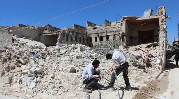 In this photo taken Aug. 20, 2016 and provided by the local council of Aleppo city, Syrians workers fix electricity cables after airstrikes, in Aleppo, Syria. The opposition-held districts of the Syrian city have been surrounded and under siege for months. Russian and Syrian warplanes are bombing the streets into rubble and government forces are chipping away at the pocket of opposition control. (Local Council of Aleppo City via AP)