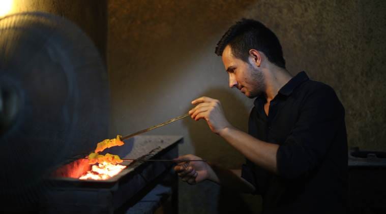 Omar Khadim with his popular kebabs in Kabul Restaurant. (Source: Express photo by Oinam Anand)