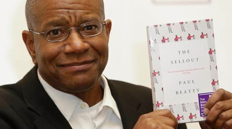 Paul Beatty, from the United States, winner of the 2016 Man Booker Prize for fiction poses for the media with his book "The Sellout" after the award ceremony in London, Tuesday, Oct. 25, 2016. Beatty's "The Sellout," a stinging satire of race and class in the United States, has won the prestigious Man Booker Prize. (AP Photo/Alastair Grant)