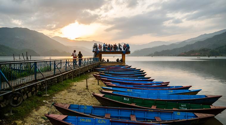 Fewa lake at sunset with row of boats at the foreground , Pokhara , Nepal