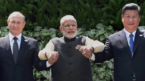 Benaulim: Prime Minister Narendra Modi with Chinese President Xi Jinping and Russian President Vladimir Putin posing for a group photo at the start of the BRICS Summit in Benaulim, Goa on Sunday. PTI Photo by Subhav Shukla (STORY DEL 17, 26)  (PTI10_16_2016_000029A)