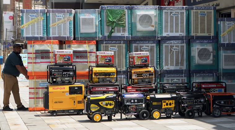 FILE - In this Thursday, July 30, 2015 file photo, air conditioners and power generators are displayed on a street in central Baghdad, Iraq. Nations reached a deal Saturday, Oct. 15, 2016 to limit the use of hydrofluorocarbons, or HFCs - greenhouse gases far more powerful than carbon dioxide that are used in air conditioners and refrigerators, in a major effort to fight climate change. (AP Photo/ Khalid Mohammed, File)