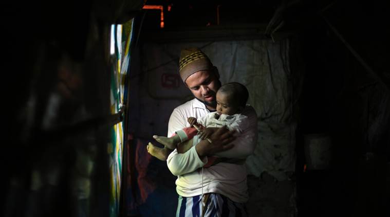 Mohammad Salim with his child at home in Delhi. (Source: Express photo by Oinam Anand)