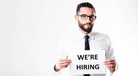 office worker or businessman with glasses showing his company is going to hire