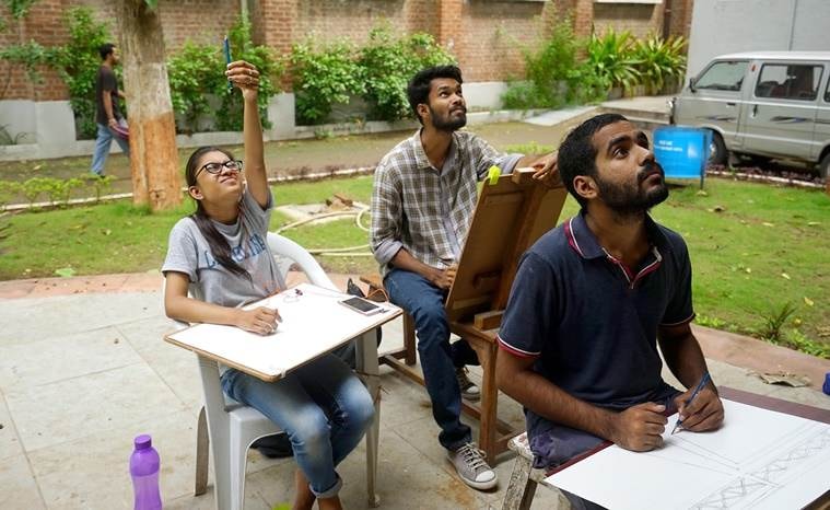 Students sketch and paint on the verdant campus.