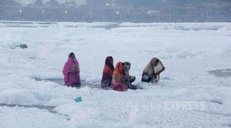 Women take a dip in the Yamuna on the occasion of Chhath Puja. (Source: Express Photo by Gajendra Yadav)