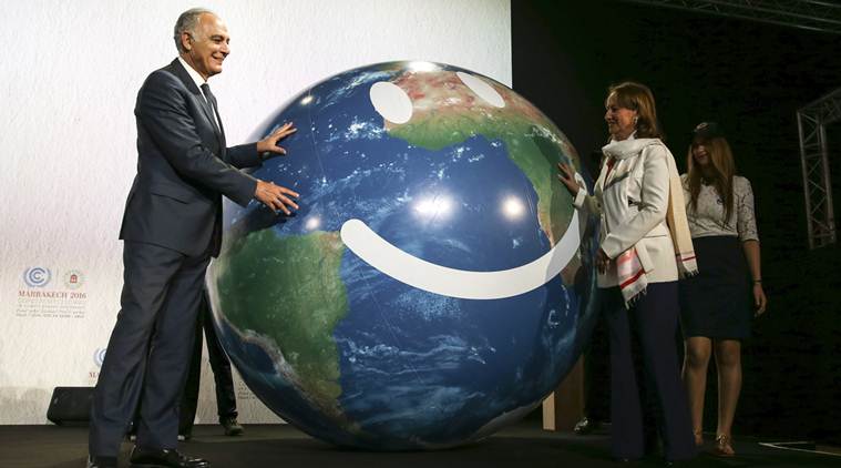Climate conference president Salaheddine Mezouar and French Environment Minister Segolene Royal, right, stand next to a globe during the opening session of the Climate Conference in Marrakech, Morocco, Monday Nov. 7, 2016. Climate negotiators have started work on implementing the Paris pact on global warming amid uncertainty over how the U.S. election will impact the landmark deal as temperatures and greenhouse gases soar to new heights. (AP Photo/Mosa'ab Elshamy)