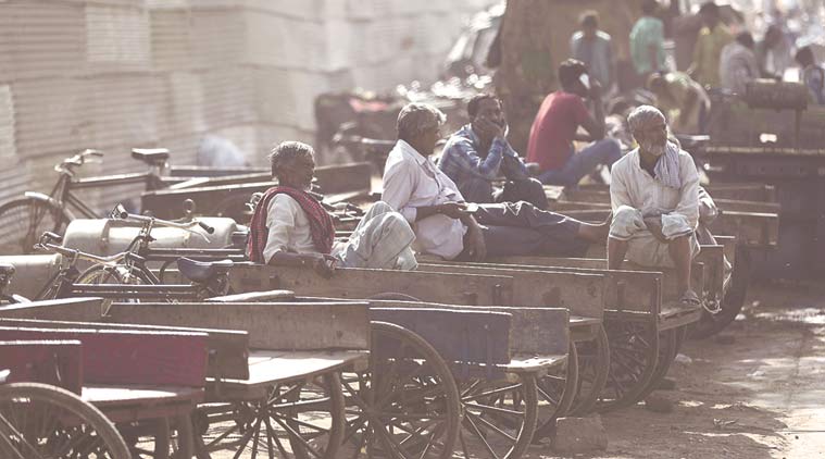 Daily wage labourers, who have been struggling to get work since demonetisation was announced, at Meena Bazar behind Jama Masjid on Wednesday. (Express Photo by Abhinav Saha)
