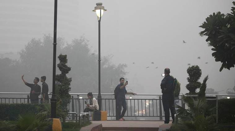 Indians take selfies at a public park enveloped by thick smog in New Delhi, India, Saturday, Nov. 5, 2016. According to one advocacy group, government data shows that the smog that enveloped New Delhi this past week was the worst in the last 17 years. The concentration of PM2.5, tiny particulate pollution that can clog lungs, averaged close to 700 micrograms per cubic meter. That's 12 times the government norm and a whopping 70 times the WHO standards. (AP Photo/Altaf Qadri)