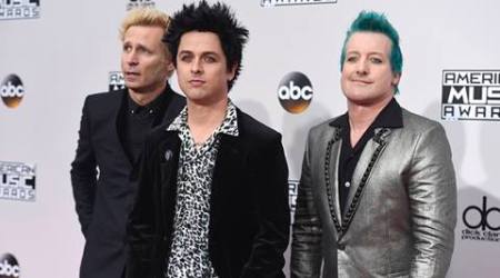Mike Dirnt, from left, Billie Joe Armstrong, and Tre Cool, of Green Day, arrive at the American Music Awards at the Microsoft Theater on Sunday, Nov. 20, 2016, in Los Angeles. (Photo by Jordan Strauss/Invision/AP)