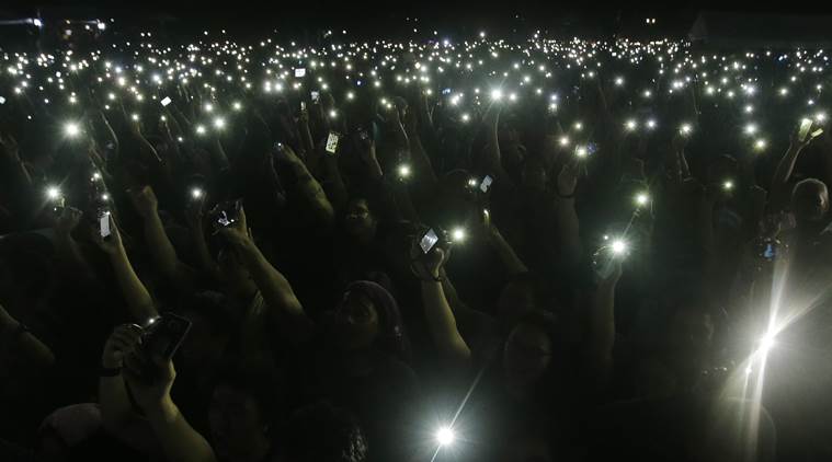 Protesters use their smartphones as part of an activity during a rally at Manila's Rizal Park, Philippines Friday Nov. 25, 2016 against the hasty burial of Philippine dictator Ferdinand Marcos in a heroes' cemetery. Thousands of Filipinos, including more than a dozen nude students, have protested the hasty burial of Marcos in a heroes' cemetery in a growing political storm that's lashing Philippine President Rodrigo Duterte who allowed the entombment. (AP Photo/Aaron Favila)