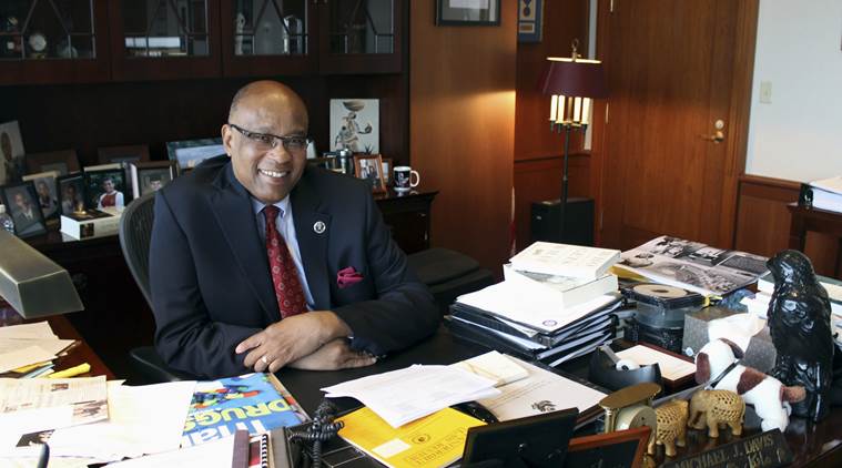 FILE - In this July 8, 2015 file photo, U.S. District Judge Michael Davis poses in his chambers in Minneapolis. David handed down sentences in November 2016 in a case that targeted a group of nine male friends in Minnesota's large Somali community who prosecutors say helped radicalize each other. The sentences he handed down are expected to set a pattern for other terrorism cases across the country. (AP Photo/Jeff Baenen, File)