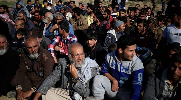 Men who just fled the Samah district of eastern Mosul wait to go through interrogations to ensure they do not belong to the Islamic State group at the Iraqi Special Forces checkpoint in Kokjali, east of Mosul, Iraq November 5, 2016. REUTERS/Zohra Bensemra