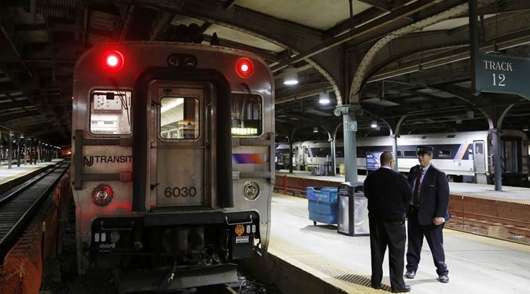 New Jersey Transit employees talk to one another after a train arrives to Hoboken Terminal in Hoboken, N.J., Monday, Oct. 10, 2016. Rail service resumed Monday at the New Jersey transit station damaged less than two weeks ago after a train crash that killed a woman on the platform and injured more than 100. (AP Photo/Seth Wenig)