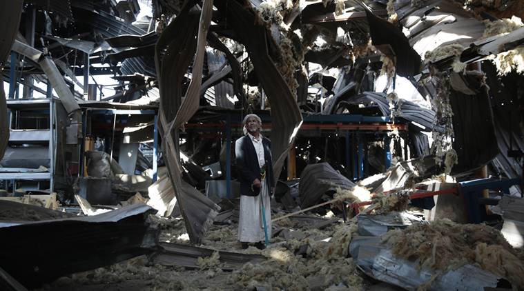 In this Sept. 22, 2016 photo, Massoud Abdullah Azzan, 75, who is a doorkeeper, stands amid the rubble of Alsonidar Group's water pumps and pipes factory after it was hit by Saudi-led airstrikes, in Sanaa, Yemen. In the air campaign by Saudi Arabia and its allies against YemenÄôs Shiite rebels, rights experts say there has been a pattern by the Saudi-led coalition in depending on faulty intelligence, failing to distinguish between civilian and military targets and disregarding the likelihood of civilian casualties. Experts say some of the strikes likely amount to war crimes. (AP Photo/Hani Mohammed)