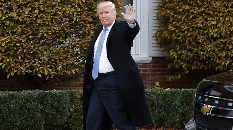 FILE - In this Nov. 20, 2016 file photo, President-elect Donald Trump waves as he arrives at the Trump National Golf Club Bedminster clubhouse in Bedminster, N.J. Thousands of high school students from Seattle to Silver Spring, Md., have taken to the streets since Trump's election to protest his proposed crackdown on illegal immigration and his rude comments about women. (AP Photo/Carolyn Kaster, File)