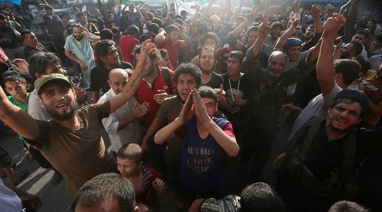 Rebel fighters and people carry opposition and Jabhat Fatah al-Sham flags as they celebrate the news of the breaking of the siege of rebel-held areas of Aleppo, Syria August 6, 2016. REUTERS/Abdalrhman Ismail SEARCH "ALEPPO TIMELINE" FOR THIS STORY