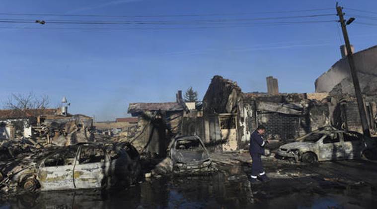 Firefighters work at the scene after a tanker train derailed and gas tank exploded in the village of Hitrino, northeastern Bulgaria, early Saturday, Dec. 10, 2016. Firefighters said the explosion caused deaths and many more injured when a train derailed and containers of liquefied petroleum gas exploded, destroying at least 20 buildings in the village. (Petko Momchilov/Sky Pictures Bulgaria via AP)