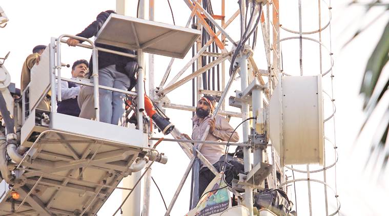 Teacher Deepak Kumar on the mobile tower in Sector 3 on Friday. Kamleshwar Singh